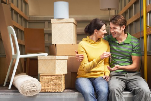Professional movers handling furniture for a home move in West Hendon